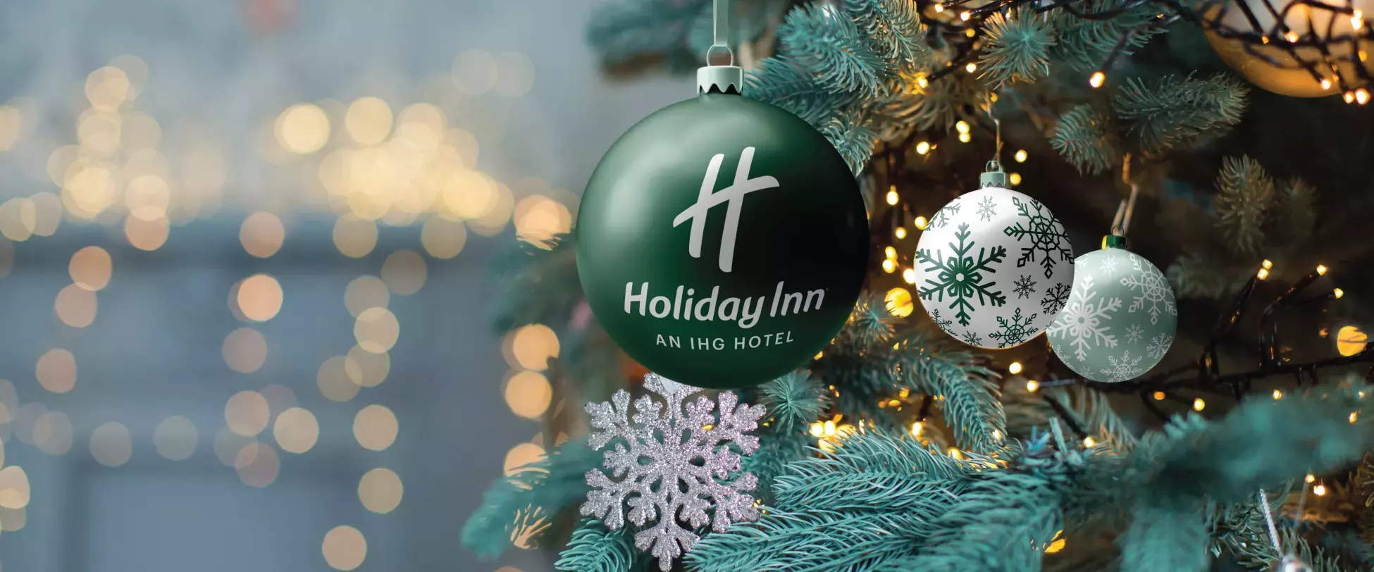 A Holiday Inn Bauble hanging in a Christmas tree.